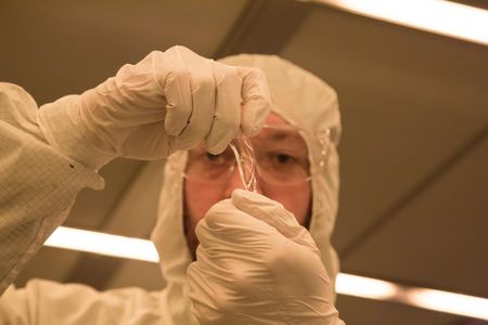 A researcher tests the sensor's stretchability.
