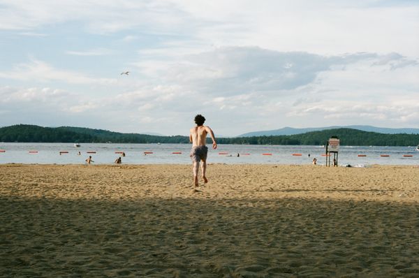 A young man running toward the water thumbnail