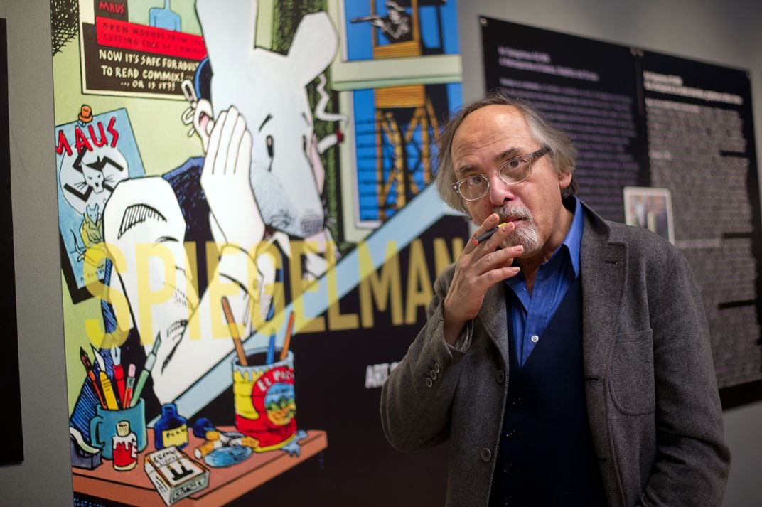 Art Spiegelman poses next to an illustration from his seminal comic memoir Maus on March 20, 2012, prior to an exhibition of his work.