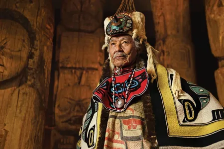 At the Totem Heritage Center in Ketchikan, Alaska, Nathan Jackson wears ceremonial blankets and a headdress made from ermine pelts, cedar, abalone shell, copper and flicker feathers.