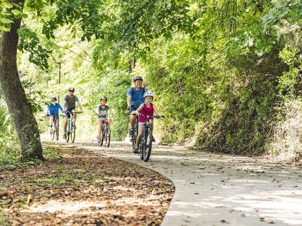 Family riding bikes on paved trail