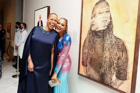 Rhea L. Combs (left) and Ava DuVernay (right) share a laugh in front of DuVernay&rsquo;s portrait during the National Portrait Gallery's 2022 Portrait of a Nation Gala on Saturday, November 12, 2022.