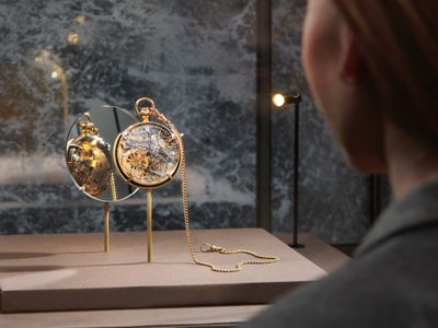 A visitor examines a watch&nbsp;crafted by&nbsp;Abraham-Louis Breguet&nbsp;for Marie Antoinette.