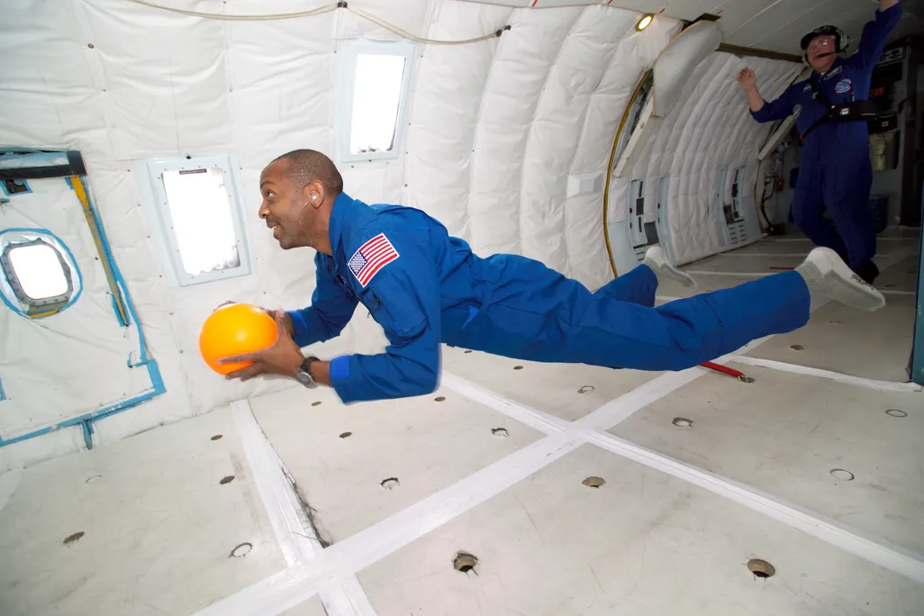 A person floats horizontally on a zero-gravity flight