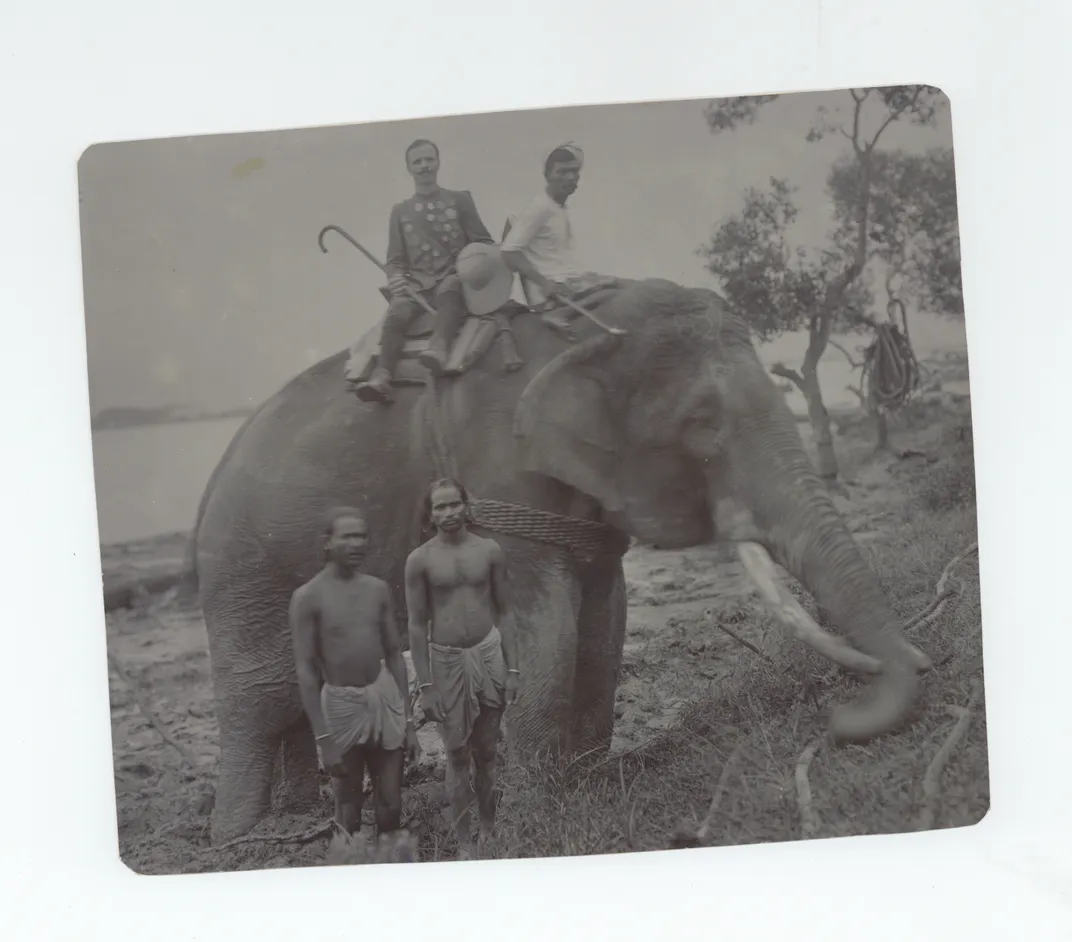 Photo of Joseph Mikulec in India, riding an elephant