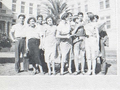 Group of teenagers in front of a school building.