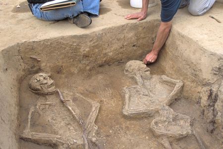 Forensic anthropologist Douglas Owsley (left) and APVA Preservation Virginia/ Historic Jamestowne archaeologist (Danny Schmidt) discussing the double burial of two European males. James Fort site, 1607.