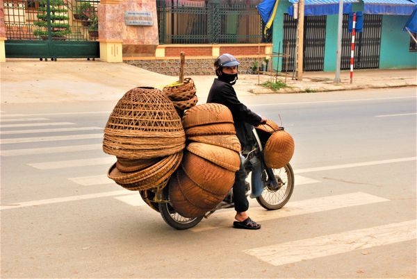 Basket vendor on a motorbike in North Vietnam thumbnail