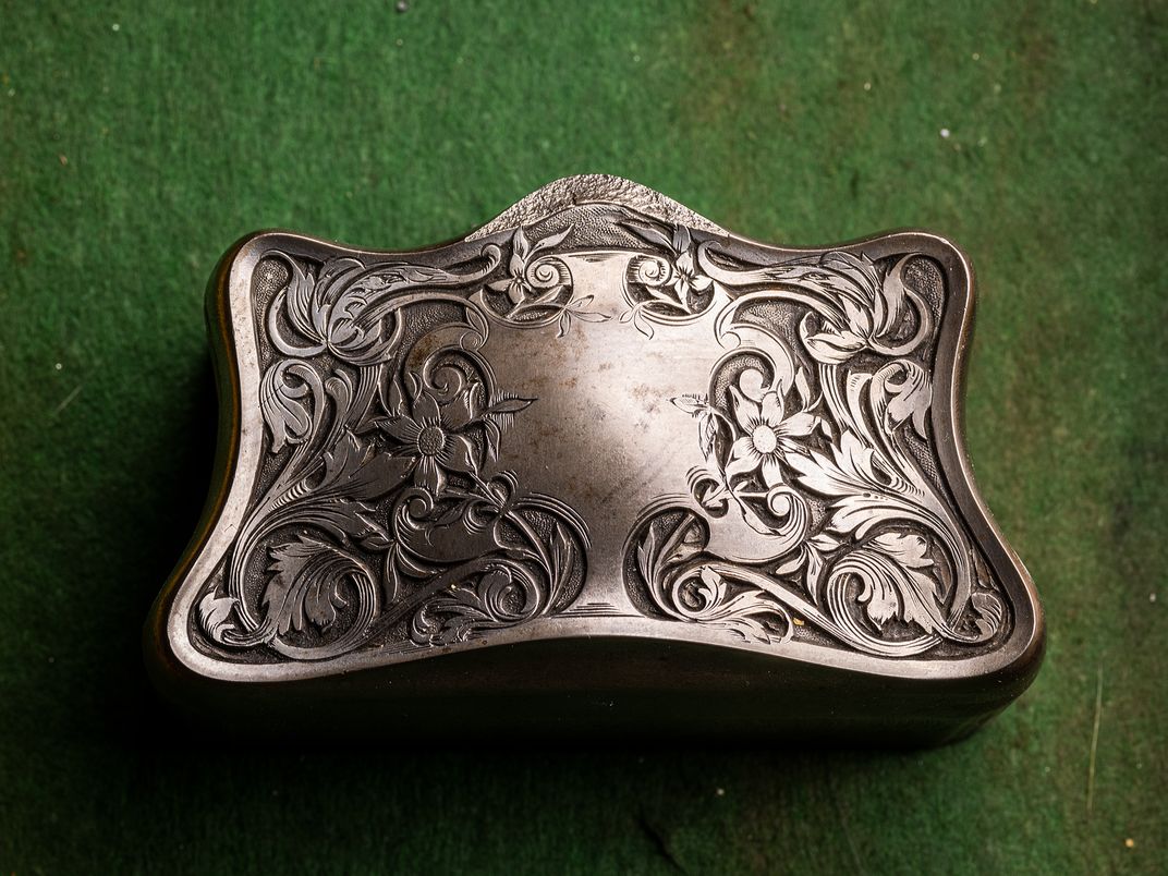 The hand-carved hub for a silver cigarette box