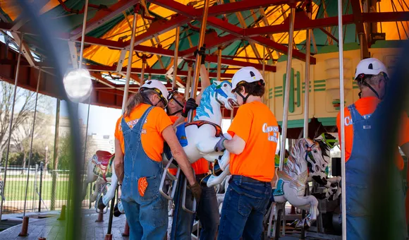 Workers install a horse in the refurbished Smithsonian carousel