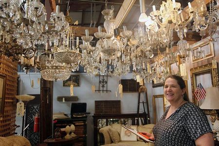 Ruthie Mundell stands among new and vintage chandeliers—all salvaged and ready to find a new home.