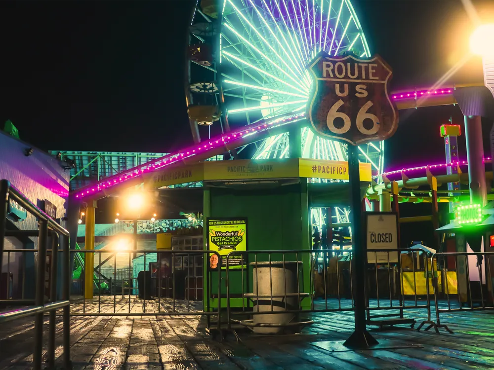 A neon ferris wheel at night