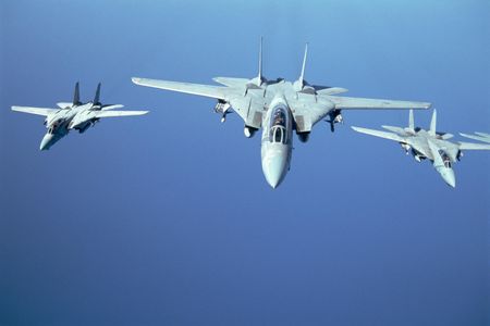 Three F-14 Tomcats fly in a tight formation over the Red Sea during Operation Desert Storm. The F-14s primary function was to intercept multiple airborne threats in all weather conditions and at night. 