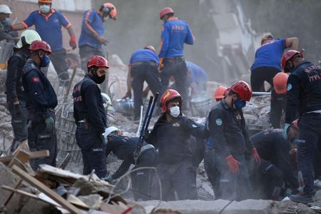 Search and rescue teams search for survivors in the debris of fallen buildings in Izmir, Turkey. 