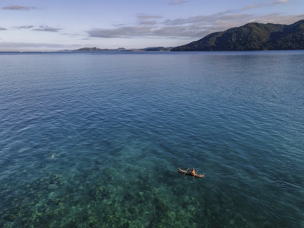 On an island near Nosy Be, we stayed for days without electricity. When this pirogue drifted over the reef, I used one of my few drone batteries, managing every charge carefully to keep equipment running in the isolated setting.