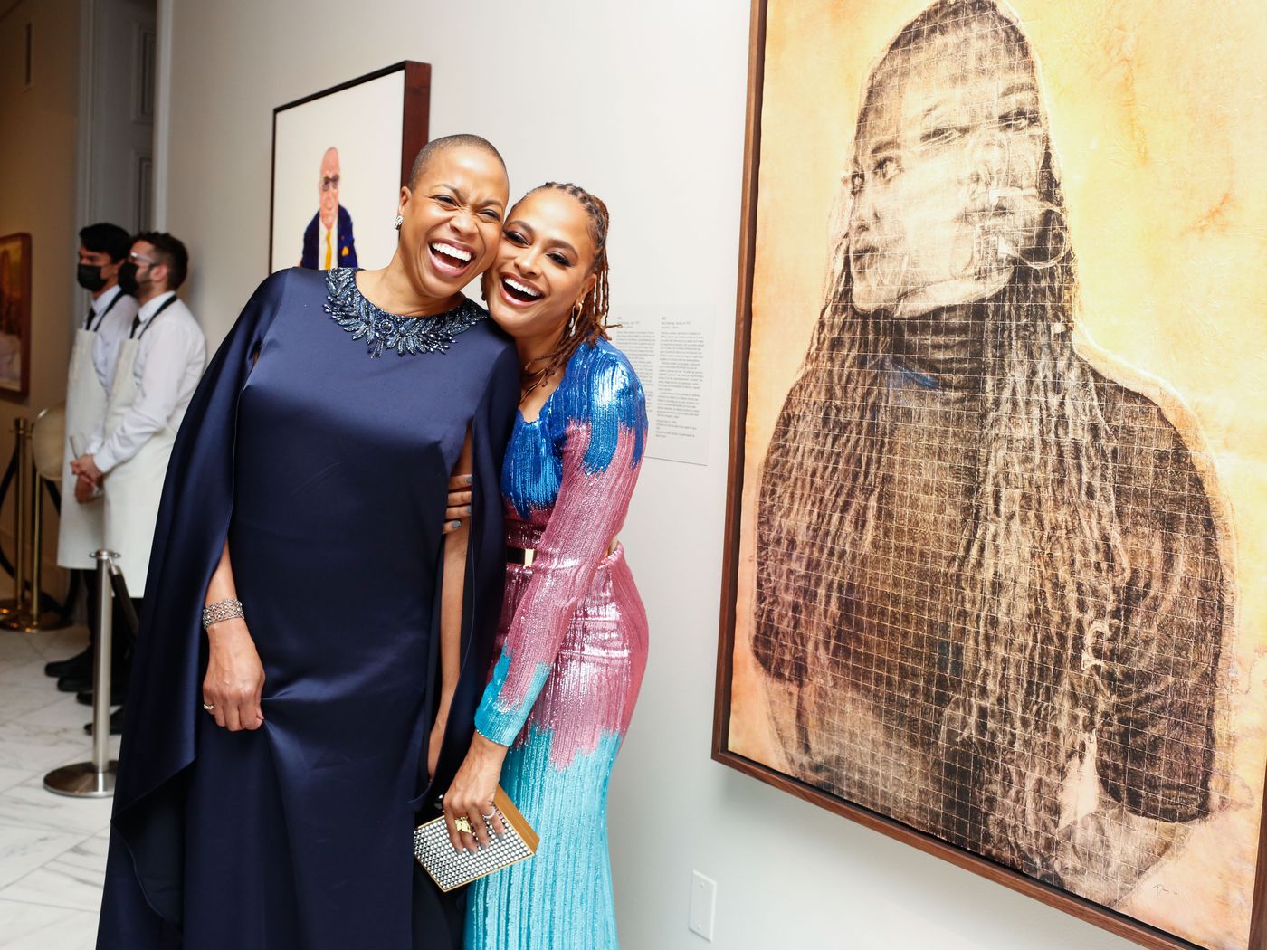 Rhea L. Combs (left) and Ava DuVernay (right) share a laugh in front of DuVernay’s portrait during the National Portrait Gallery's 2022 Portrait of a Nation Gala on Saturday, November 12, 2022.