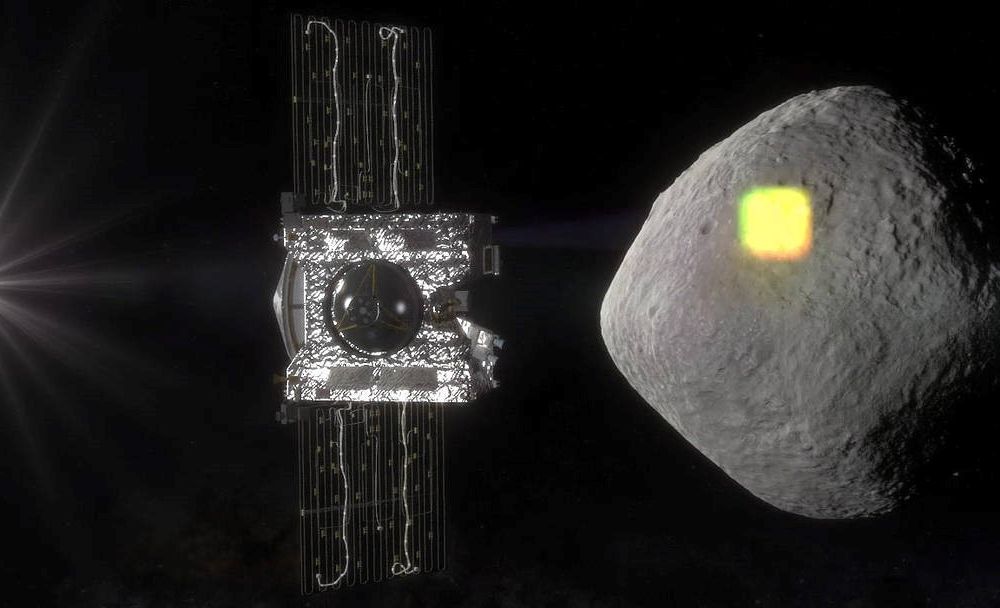 Bennu is shaped like a three-dimensional diamond and seemingly smooth from far away. OSIRIS-REx is in the foreground of this artist’s replication. The spacecraft will gather a sample from Bennu next week. (NASA/Goddard/University of Arizona)