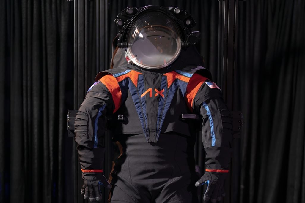 Dark grey space suit against black backdrop