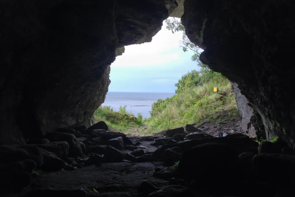 The view from inside a cave looking out at the sea