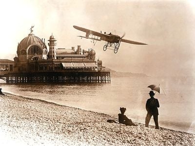 Six years after Wilbur Wright wowed the crowds at LeMans, Henri Salmet pilots his Blériot XI-2, The Daily Mail, along the scenic beaches of Nice in 1914. Though by that time airplanes were beginning to be more common, they still made people stop and stare.