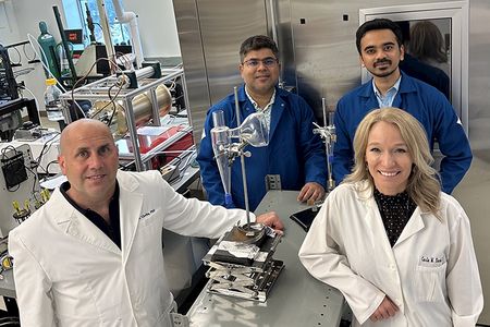 The research team stands alongside the SARS-CoV-2 wet cyclone aerosol sampler they developed.