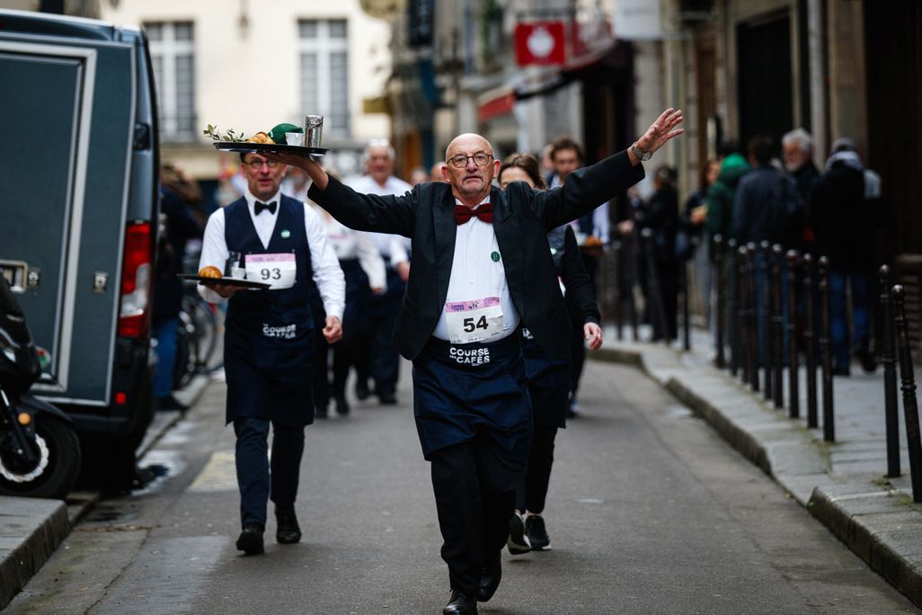 Waiter holding a tray with arm outstretched