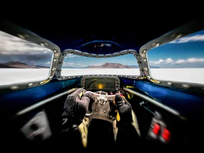 Racer Danny Thompson’s view from inside the cockpit of the Challenger 2 during a run at the Bonneville Salt Flats in August 2016. A HANS (Head and Neck Support) safety device immobilizes his head, so the side windows are only peripherally visible from his vantage point.