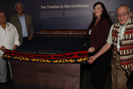Delaware leaders prepare to unveil the Treaty of Fort Pitt, on view at the National Museum of the American Indian in Washington, D.C. From left to right: Denise Stonefish, chief of the Delaware Nation at Moraviantown; museum director Kevin Gover; Chester “Chet’ Brooks, chief of the Delaware Tribe of Indians; and Deborah Dotson, president of the Delaware Nation. May 10, 2018, Washington, D.C. (Paul Morigi/AP Images for the National Museum of the American Indian, Smithsonian)