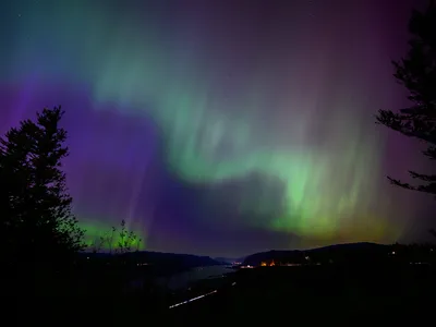 From&nbsp;Latourell, Oregon, the northern lights appear as ribbons of color in the night sky on May 11.