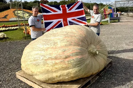 Ian and Stuart Paton pose with their world record pumpkin, nicknamed Muggle. The pumpkin weighs 2,819.3 pounds.