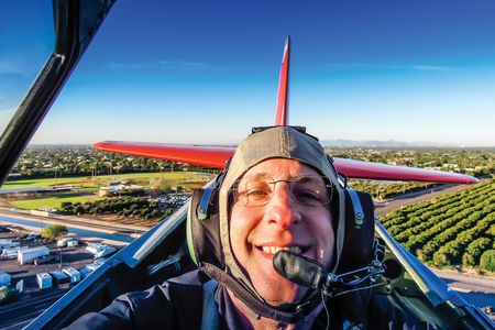 The author in November 2014, checking off a big item on his bucket list: to practice air-to-air photography from the open cockpit of a warbird.