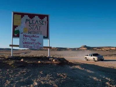 A sign asks Navajo residents to stay safe and warns of a curfew near the Navajo Nation town of Casamero Lake in New Mexico on May 20, 2020.