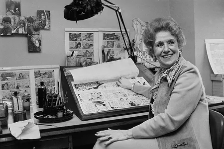 Dale Messick, creator of the comic strip "Brenda Starr," looks up from some of her strips in her studio in her Chicago apartment in 1975.