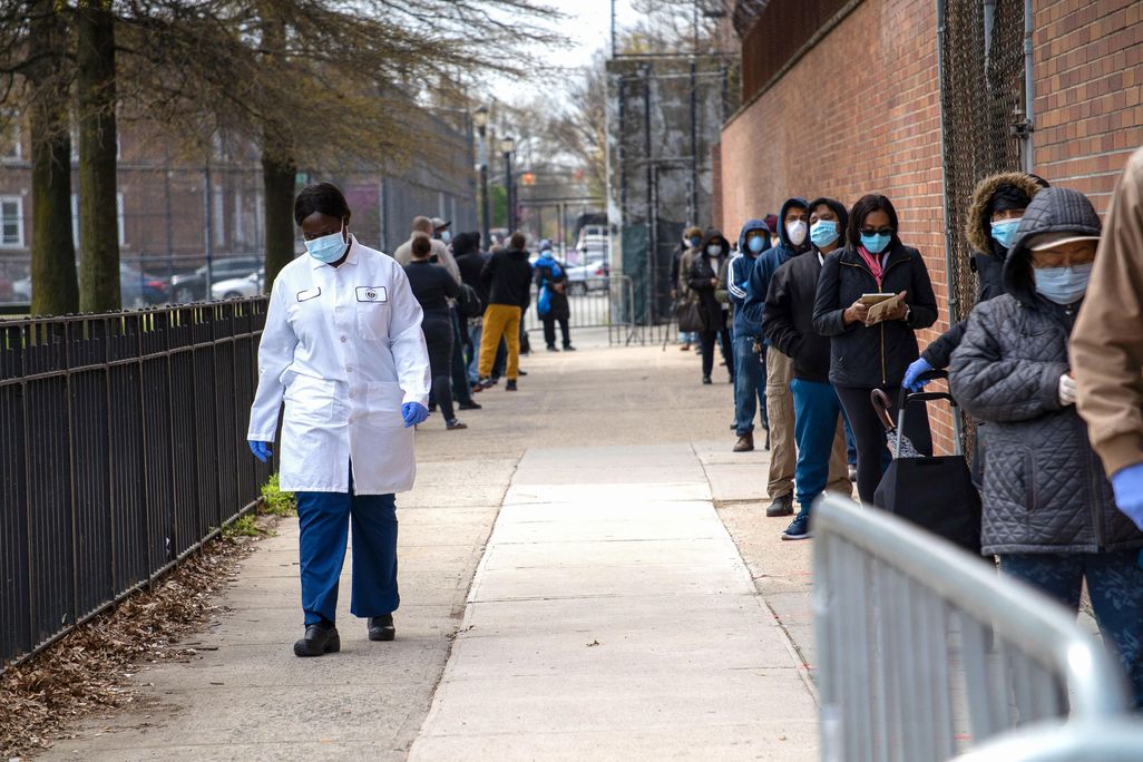 a line, mostly of people of color, waiting for COVID-19 tests in Brooklyn