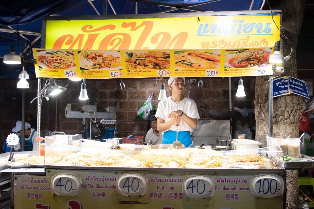 Man sells pad thai at a night market in Chiang Mai, Thailand