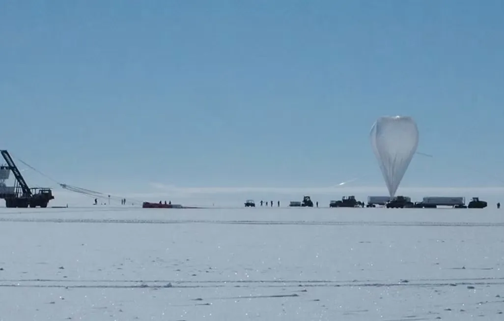 a balloon and other scientific equipment on the icy expanse of Antarctica