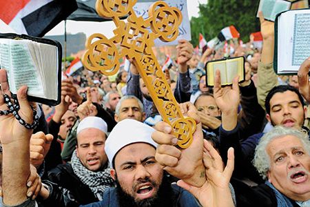 Although Christians and Muslims joined in protests against Mubarak, shown here in Cairo's Tahrir Square this past February, violence against the Copts escalated soon after the regime fell.