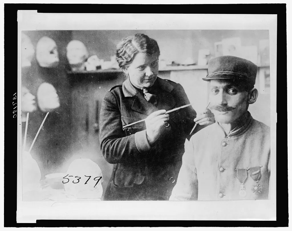 Anna Coleman Ladd, an American sculptor who designed facial prosthetics for injured soldiers, works on a mask in her studio in July 1918.