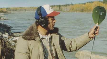 A biologist with a salmon tracking device