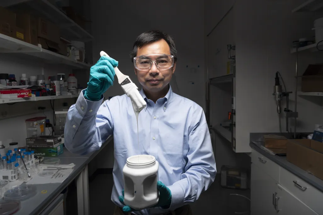 Xiulin Ruan holding paintbrush