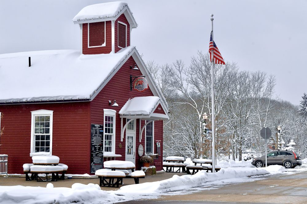 Through the expert lens of Grand Rapids based photographer Dave Thompson, the iconic Little Red Schoolhouse in Ada, Michigan, now the Ada Village General Store, takes on a new life against the hush of a snowy morning.

Thompson’s eye for composition transforms this historic red building into a visual anchor, framed with precision against the soft white blanket of snow and the muted winter light. Every detail has been rendered with clarity and care, showcasing Dave’s mastery of both timing and perspective. The image balances historical charm with contemporary artistry, inviting viewers to step into an American moment both nostalgic and immediate.