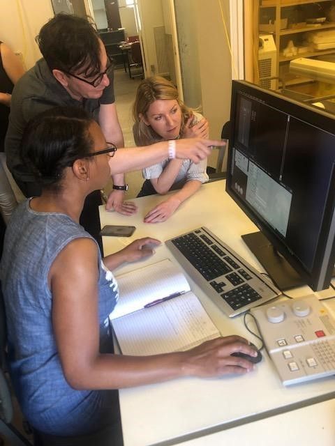 A group of people siting at a table working on a computer at the Smithsonian's National Museum of Natural History.