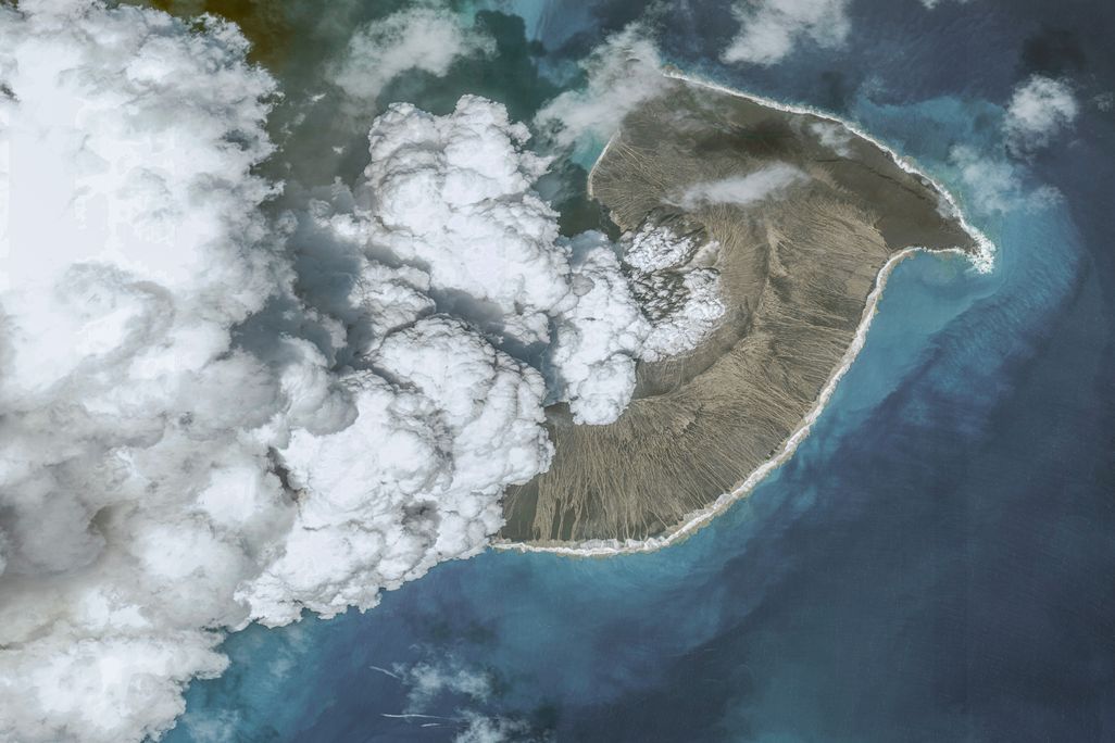 A landmass with white smoke coming out of it