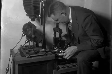 Wilmer Souder poses with a microscope—one of the newfangled tools with which he helped pioneer the field of forensic science.