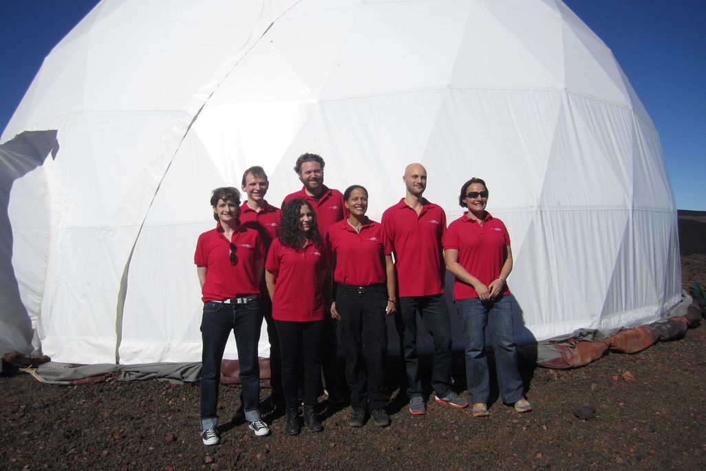 people in red polos outside a HI-SEAS habitat