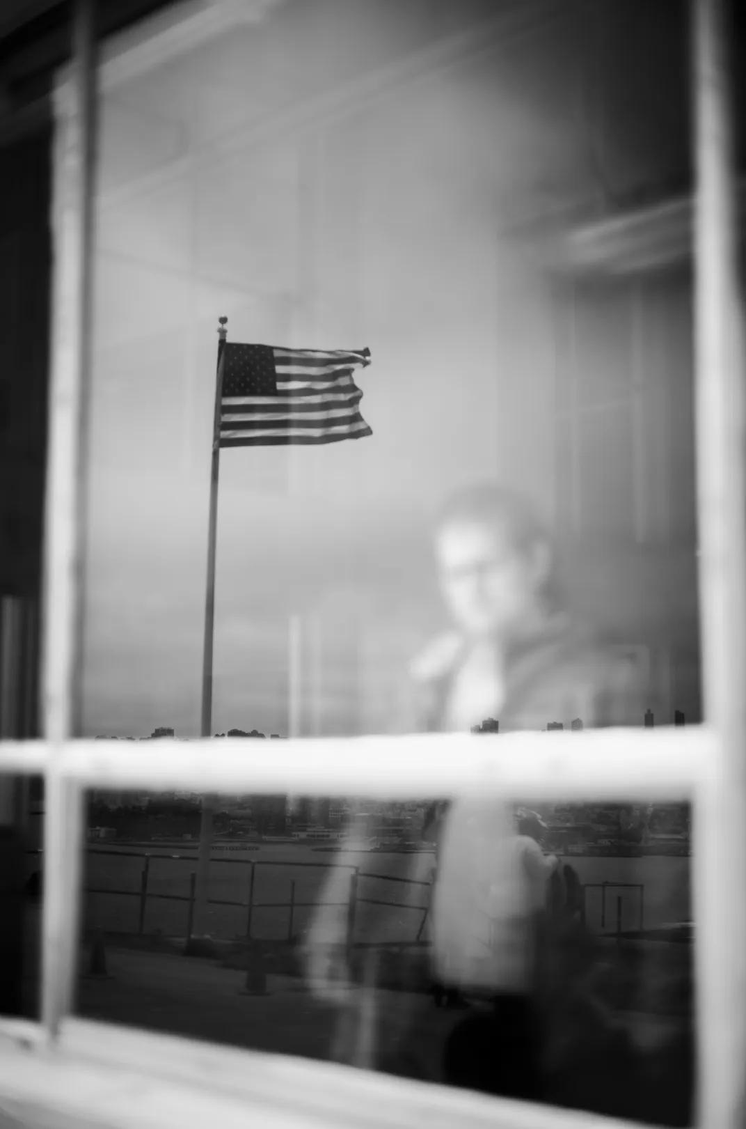 14 - An American flag is reflected in a window on Alcatraz Island in San Francisco Bay.