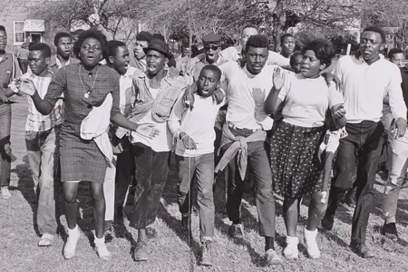 A group of young people, joyful at the success of the march, sing while walking through the St. Jude complex in Montgomery.