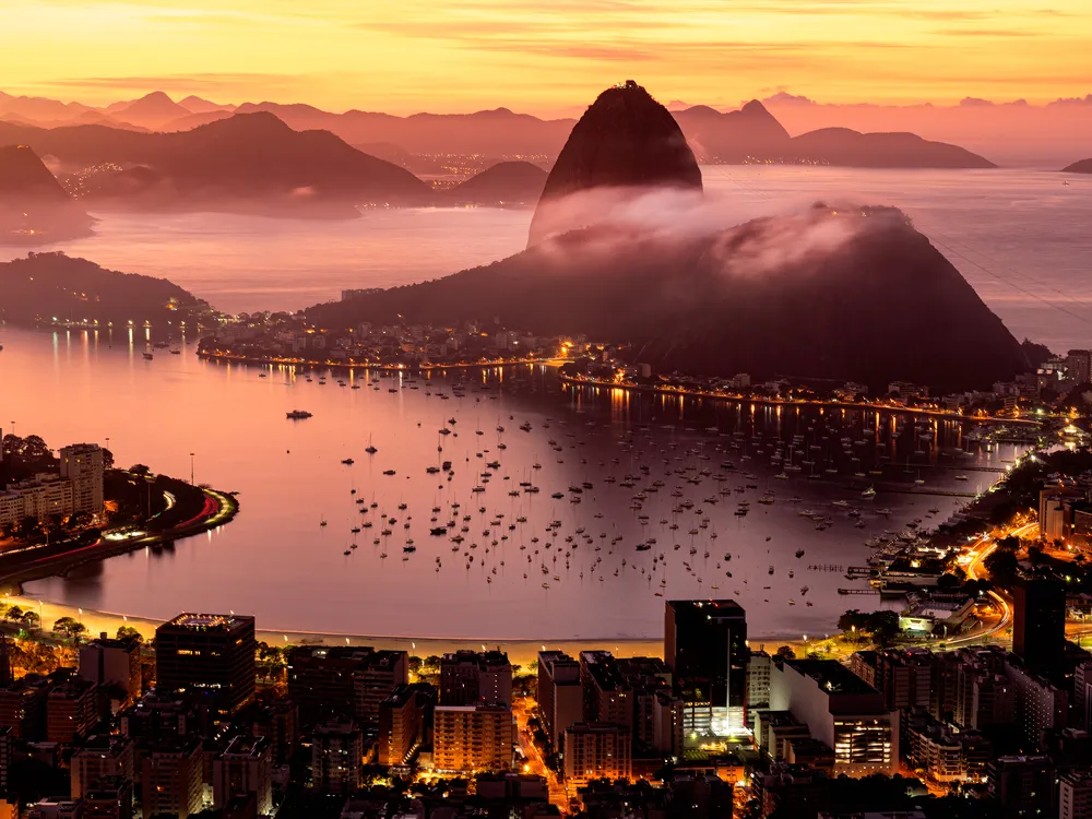 Boats, lights and fog help create a serene nighttime scene in Rio de Janeiro.