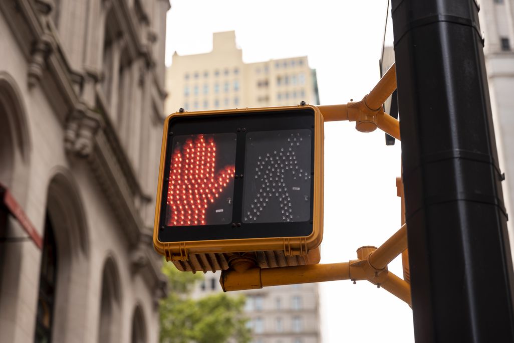 a red hand for a pedestrian crosswalk