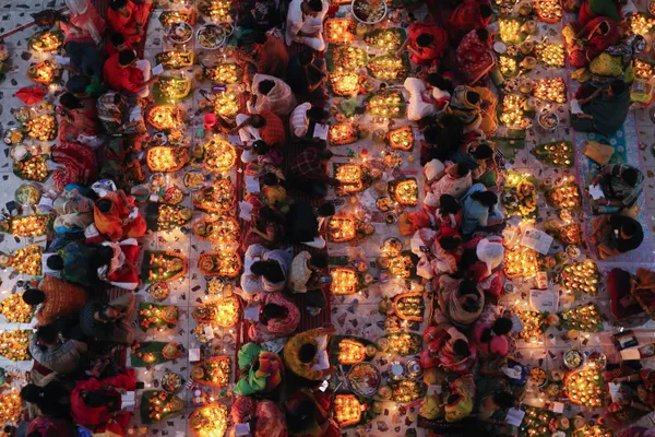 Hindu devotees praying with Lamps and foods in Fasting and Lighting of Lamps Ceremony thumbnail